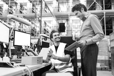 Men In Warehouse Office With Parts Stock BW